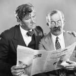 Vintage photo of two men reading a newspaper together